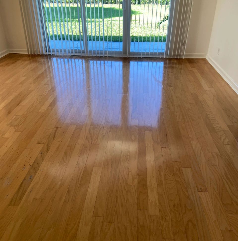 The same oak hardwood floor glowing and reflecting sunlight after a wash and buff